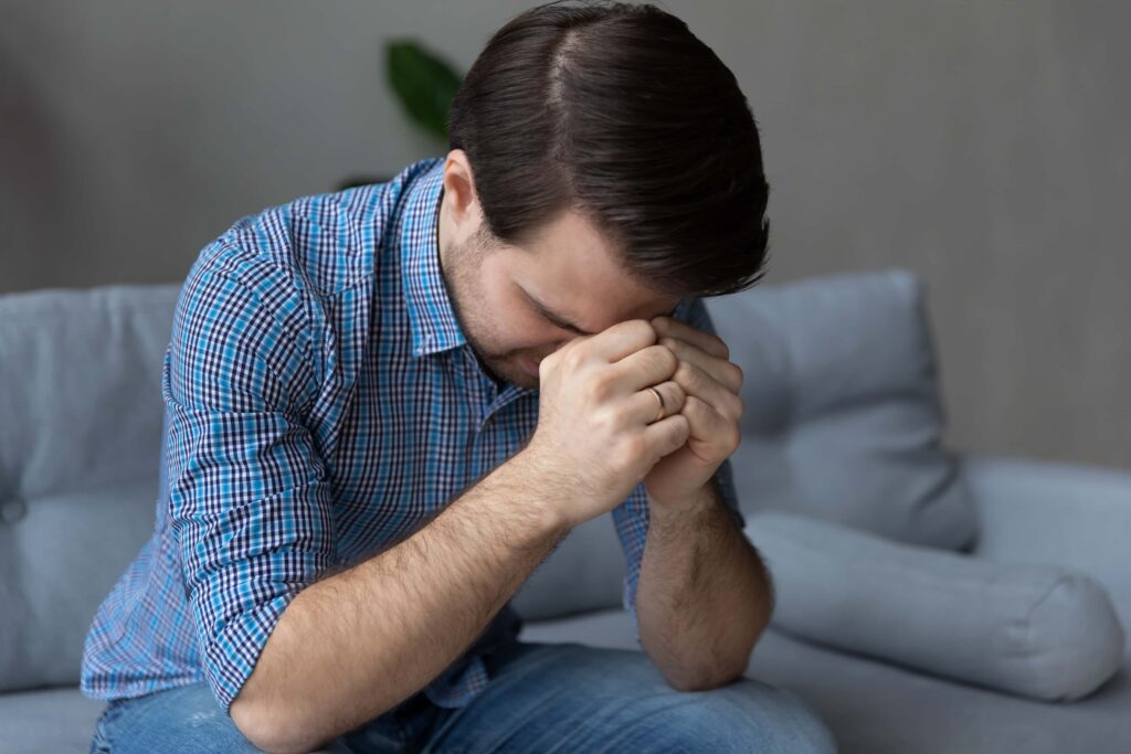 man setting in pain 