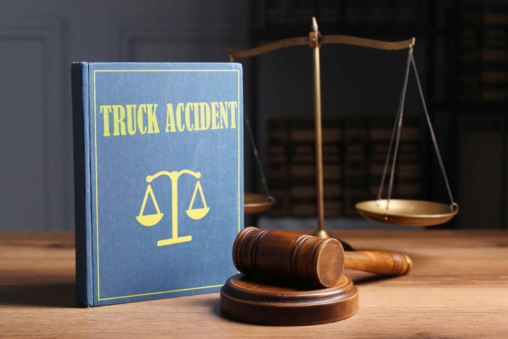 Law book labeled &ldquo;Truck Accident&rdquo; with a judge&rsquo;s gavel and scales of justice, representing truck accident law and legal claims.
