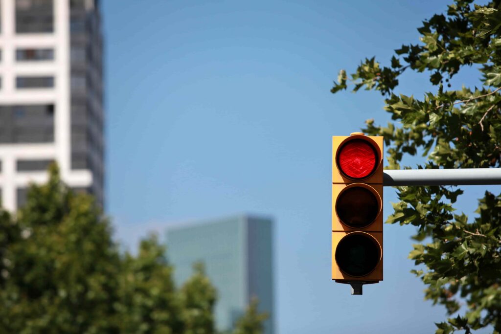 Red traffic light at a city intersection signaling drivers to stop for traffic control and road safety.