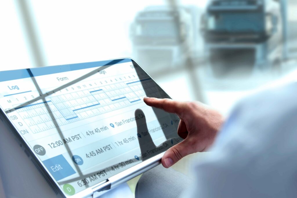 Truck driver using electronic logging device (ELD) on tablet to track hours of service and driving schedule