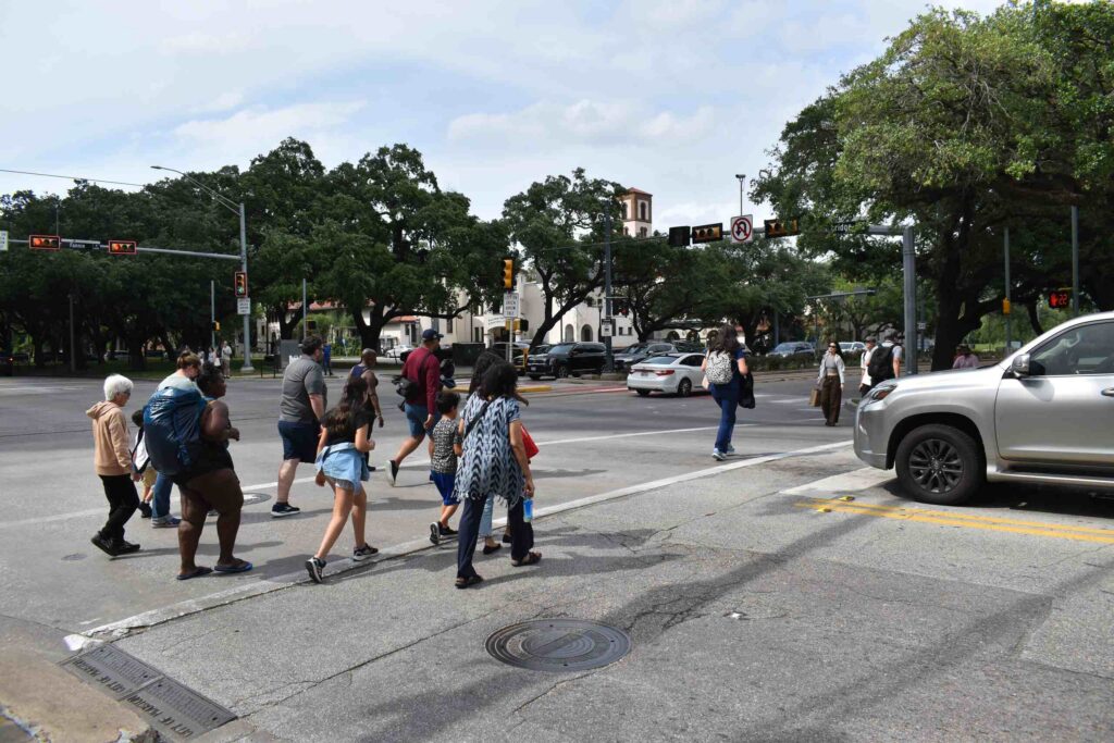 Families and pedestrians using a Texas crosswalk where a Texas pedestrian accident lawyer may investigate driver negligence and injuries