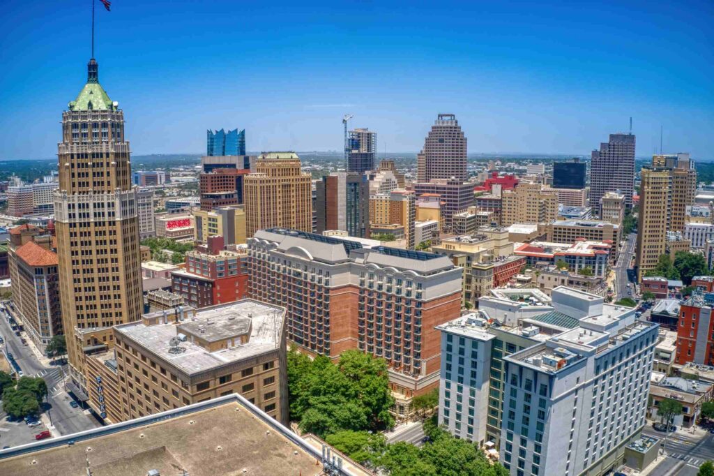 An aerial view of downtown San Antonio skyscrapers under a clear blue sky, pointing to the service area of San Antonio Hit-and-Run Accident Lawyers.