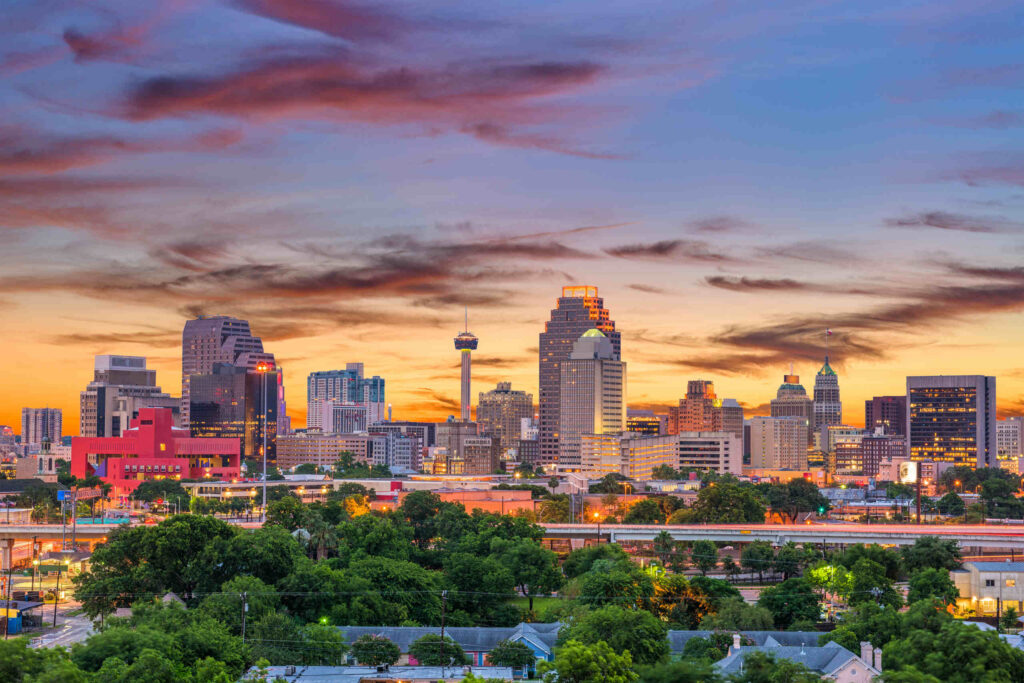 The San Antonio skyline under a dramatic sunset sky, indicating the geographic focus of San Antonio Wrongful Death Lawyers.