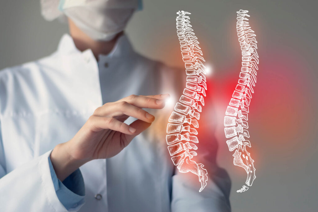 A medical professional in a lab coat pointing at an illuminated digital graphic of a human spine, relating to Spinal Cord Injury Claims in Texas & Compensation.