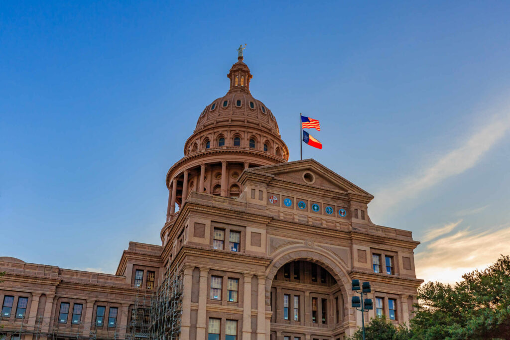 The Texas State Capitol building dome with flags, representing the statewide service area for Texas Distracted Driving Accident Lawyers.