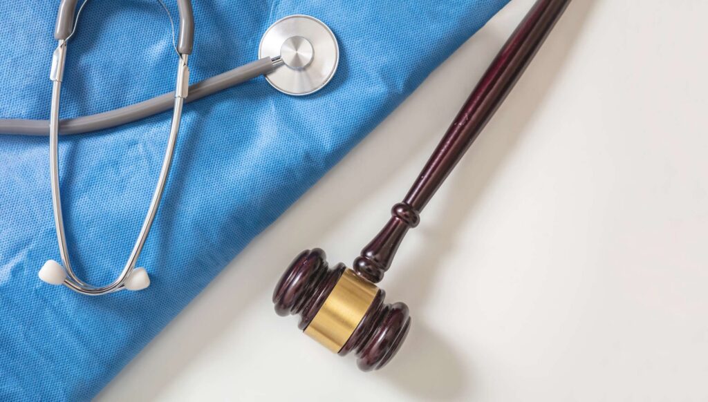 A stethoscope next to a wooden judge gavel highlights medical and legal support offered by Bryan Personal Injury Lawyers.