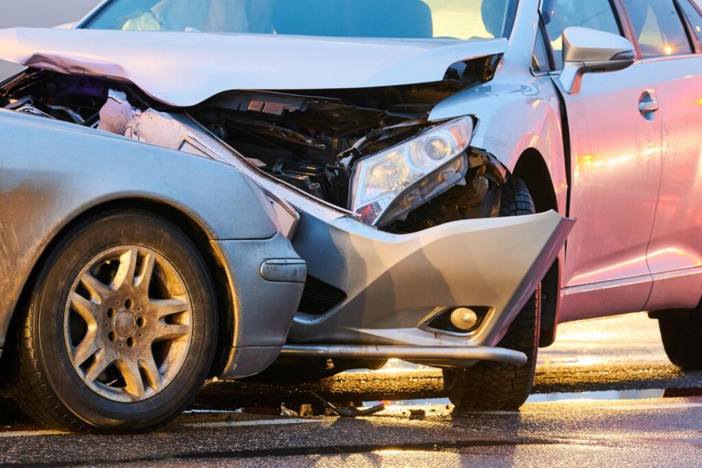 A heavy front end vehicle collision on the road illustrates a severe car accident on gameday in College Station.
