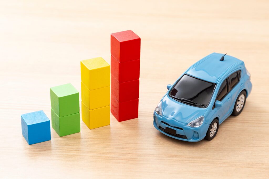 A toy blue car next to a rising bar chart illustrates the spike in car accidents on Texas A&M Game Days in College Station.