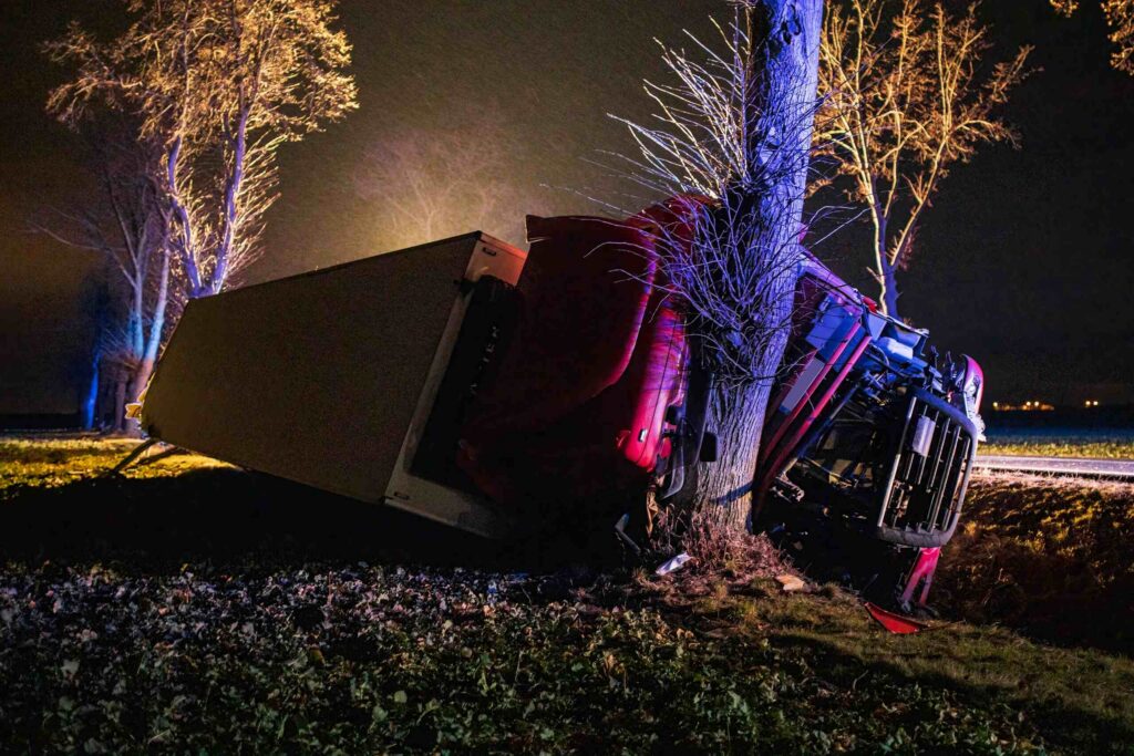 Overturned red truck crashed into a tree at night, highlighting San Antonio's dangerous intersections.