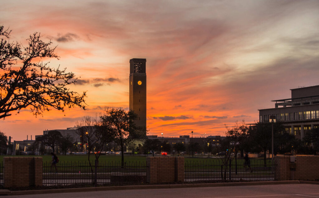 The Texas A&M campus bell tower at sunset serves as the backdrop for discussing Texas A&M Student Car Accidents.
