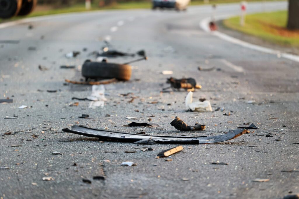 Scattered vehicle debris on a highway shows what evidence to collect after a Texas car accident.