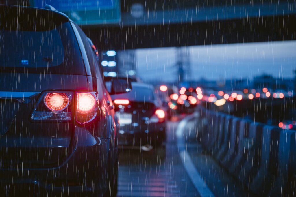 A car stopped in heavy rain and highway traffic demonstrates what evidence to collect after a Texas car accident.