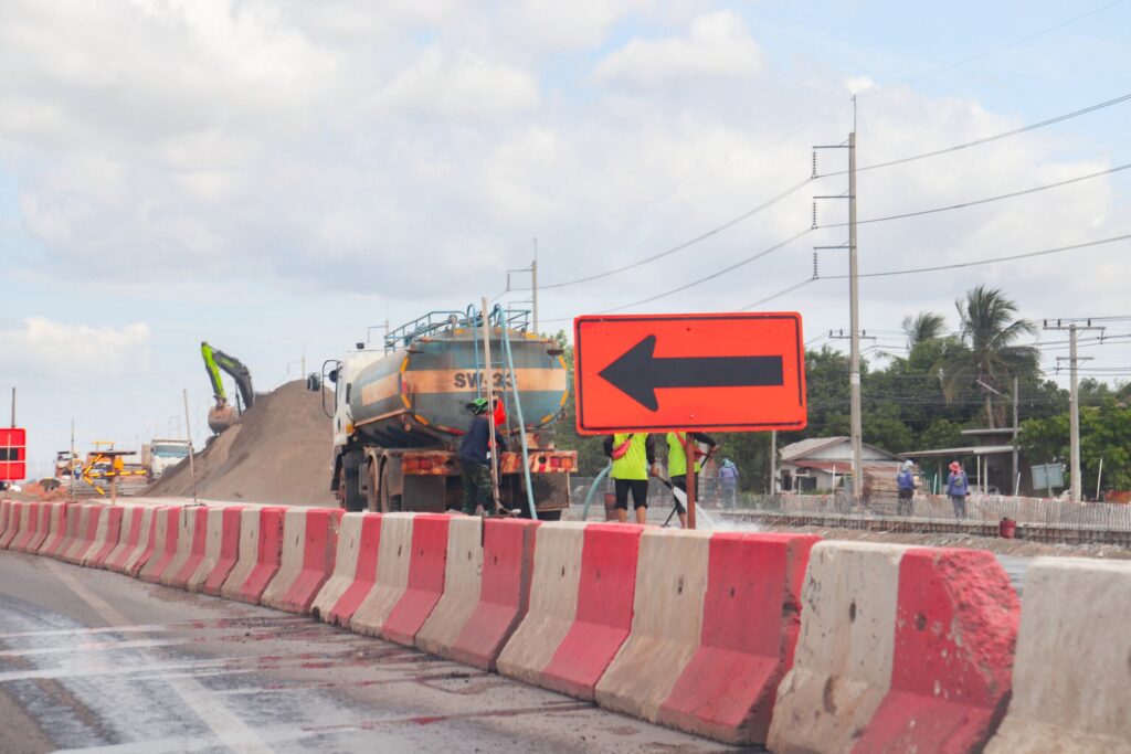 Construction machinery and traffic barriers mark an active area prone to work zone car accidents on San Antonio highways.